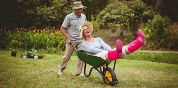 happy-couple-playing-with-wheelbarrow-procino-wells-woodland-delaware-and-maryland.jpg